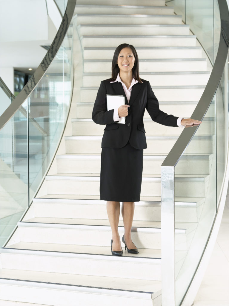 A business woman on stairs at work