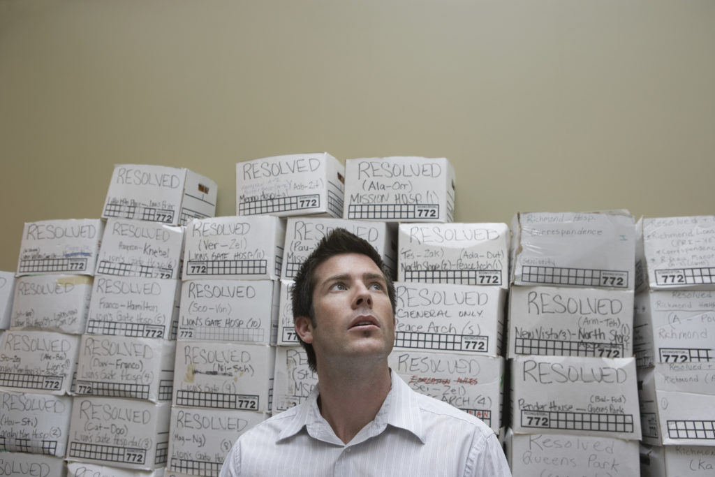 Man in front of cluttered boxes