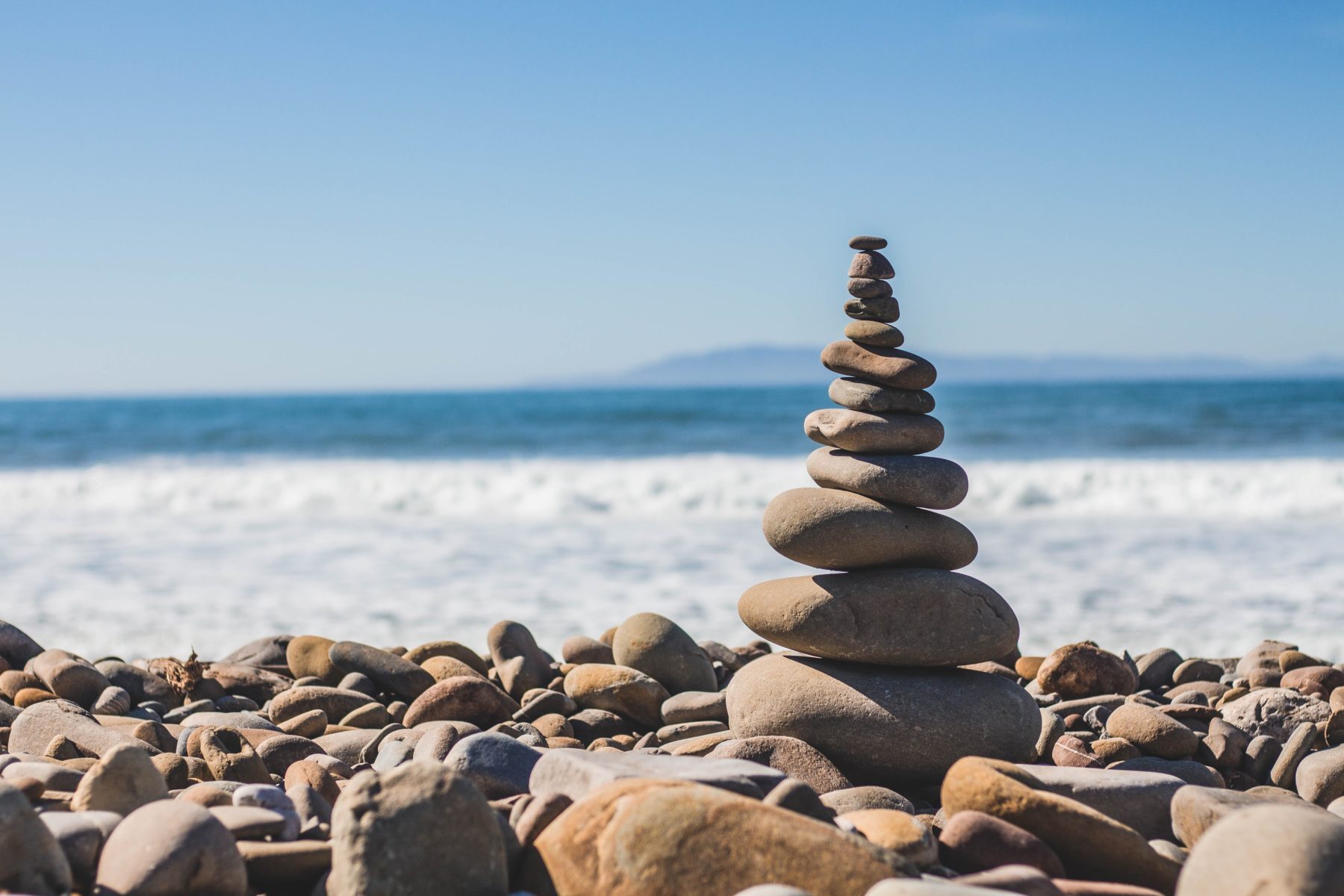 Zen cairn on rocky beach