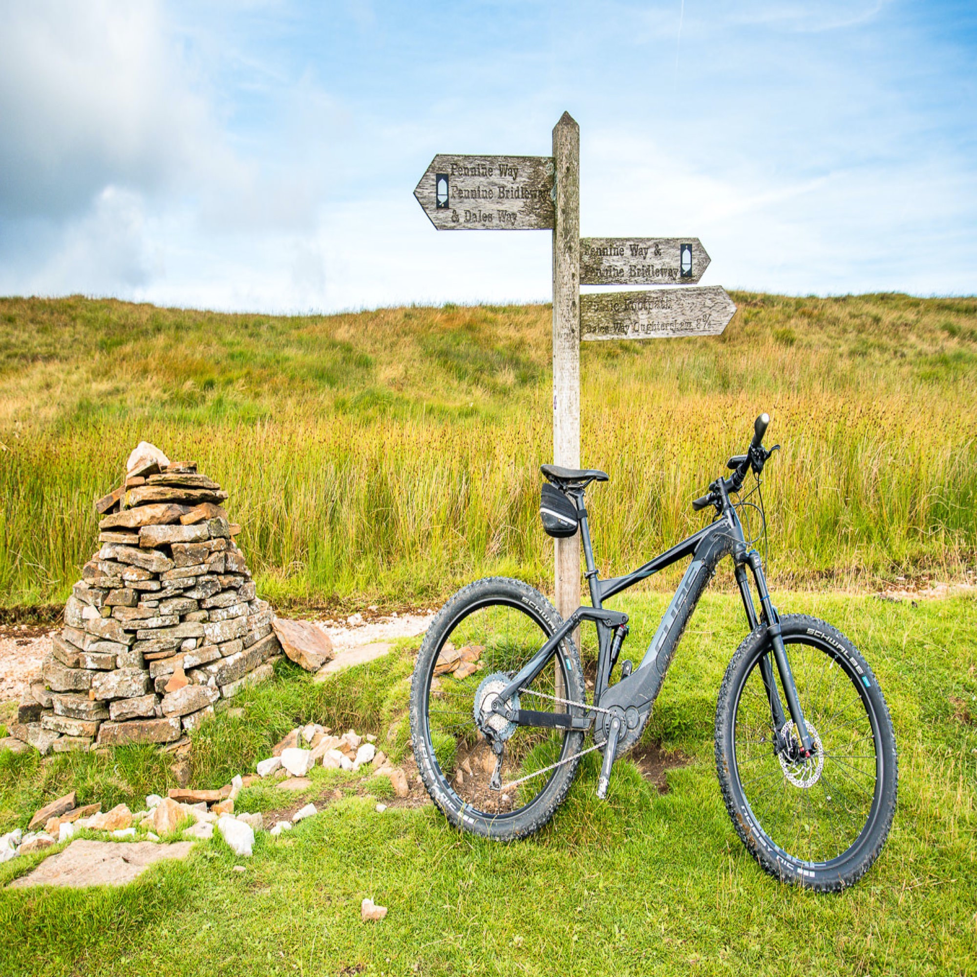 Cube Stereo Hybrid Pro at a cairn on Cam High Road during our Pennine Bridleway ride.