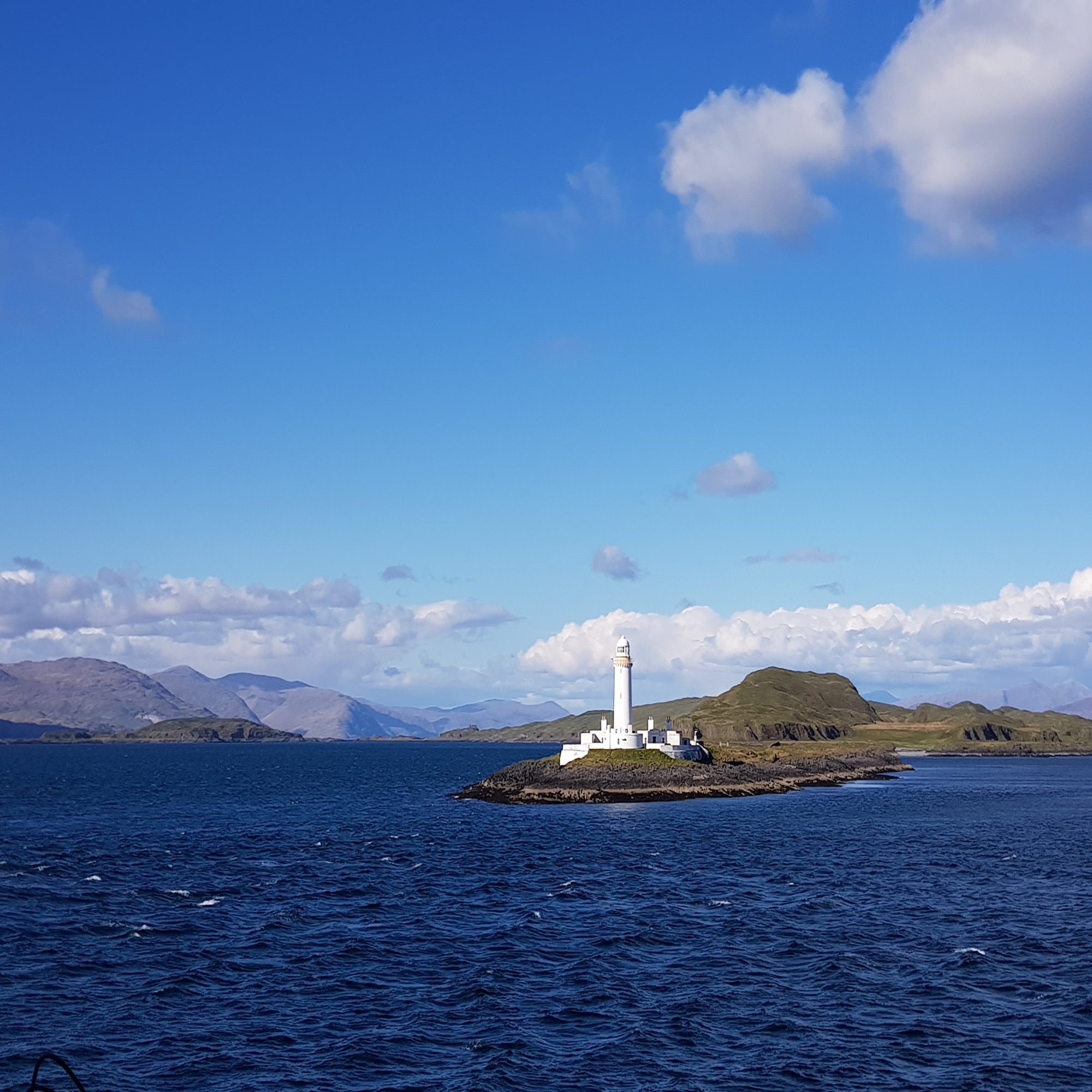 The lighthouse on Eilean Musdile from the ferry crossing to Mull