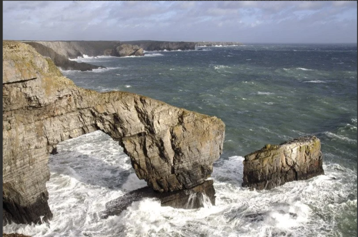 The green Bridge of Wales in Pembrokeshire gets pounded by the sea